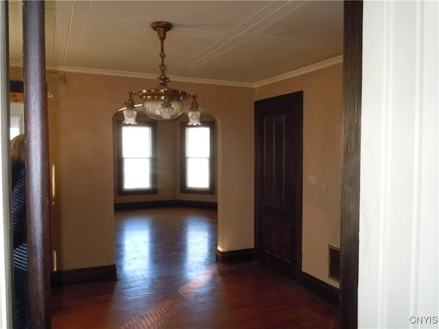 unfurnished dining area with ornamental molding and dark wood-type flooring