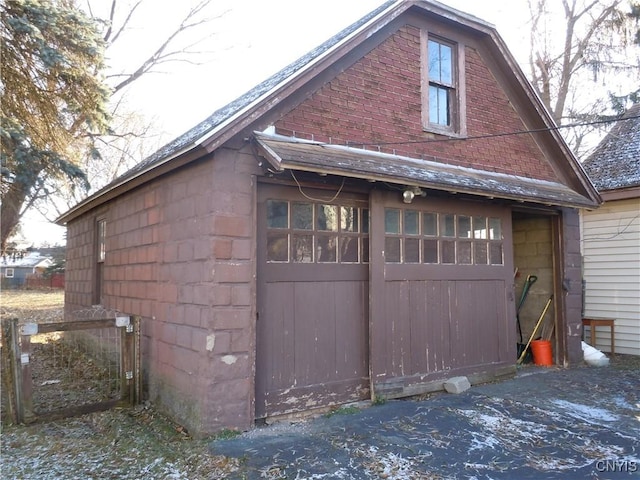 view of property exterior with a garage and an outdoor structure