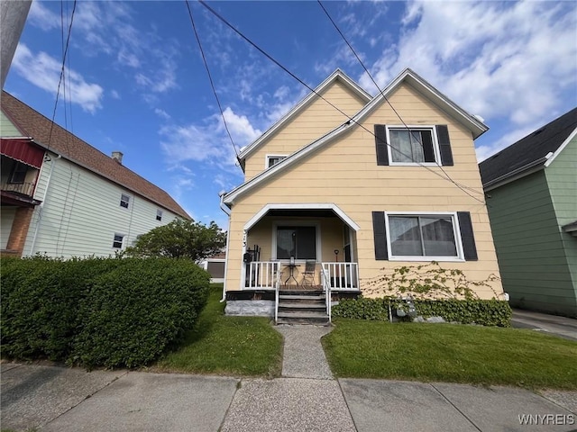 view of front of home with a porch and a front yard