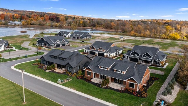 205 Charles Herrmann Way Unit 205, Milo, NY 14527 - drone / aerial view featuring a residential view, a view of trees, and a water view