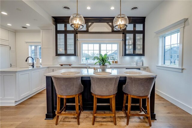 205 Charles Herrmann Way Unit 205, Milo, NY 14527 - kitchen featuring visible vents, plenty of natural light, a sink, and a center island