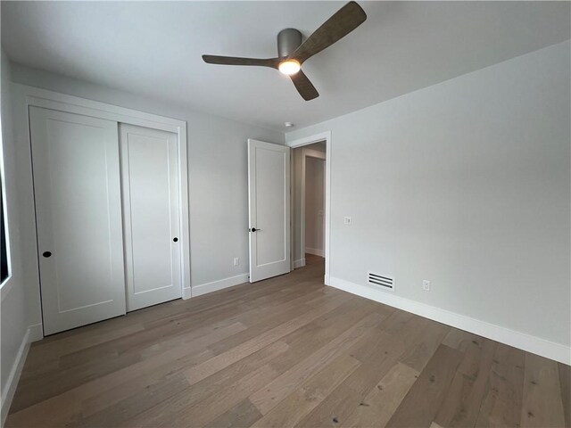 205 Charles Herrmann Way Unit 205, Milo, NY 14527 - unfurnished bedroom featuring visible vents, a closet, wood finished floors, baseboards, and ceiling fan