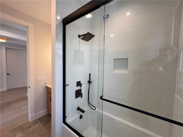 205 Charles Herrmann Way Unit 205, Milo, NY 14527 - full bath with baseboards, enclosed tub / shower combo, wood finished floors, and vanity