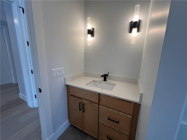 205 Charles Herrmann Way Unit 205, Milo, NY 14527 - bathroom with vanity, baseboards, and wood finished floors