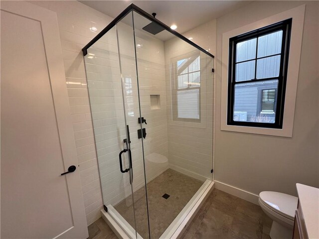 205 Charles Herrmann Way Unit 205, Milo, NY 14527 - bathroom featuring baseboards, a stall shower, and toilet