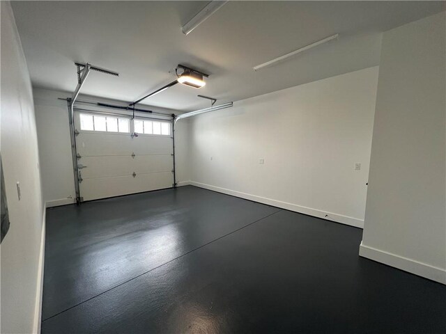 205 Charles Herrmann Way Unit 205, Milo, NY 14527 - garage featuring baseboards and a garage door opener