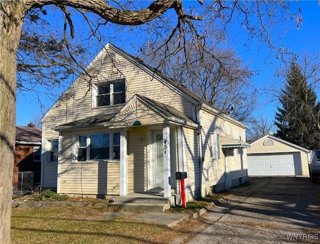 bungalow-style house featuring an outbuilding and a garage