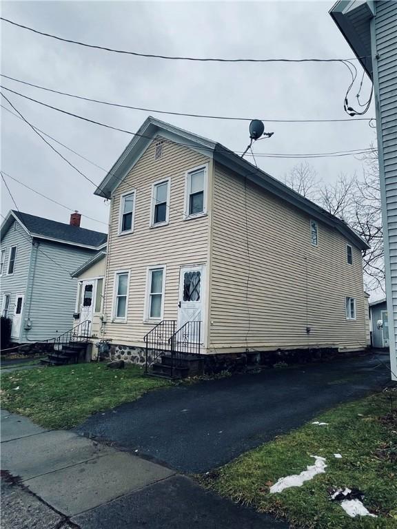 view of side of home featuring a lawn