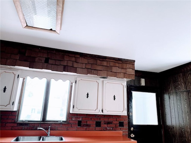 kitchen with white cabinetry and sink