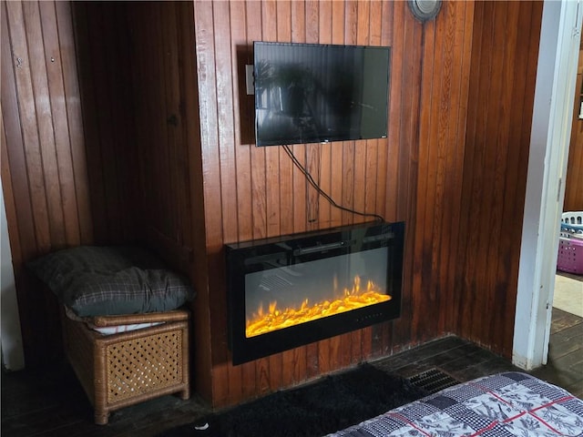 interior details featuring hardwood / wood-style flooring and wood walls