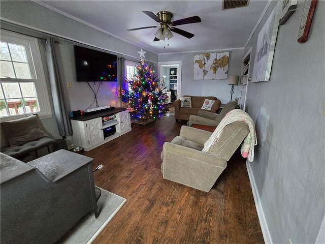 living room featuring ornamental molding, ceiling fan, and dark wood-type flooring