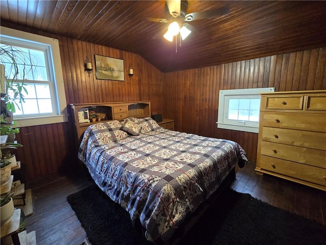 bedroom with dark hardwood / wood-style floors, ceiling fan, vaulted ceiling, and multiple windows