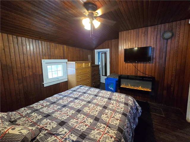 bedroom featuring ceiling fan, dark hardwood / wood-style flooring, vaulted ceiling, and wooden walls