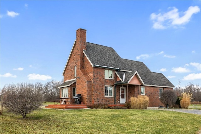 view of front of property with a wooden deck and a front yard