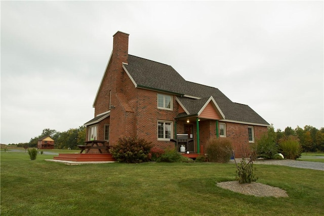 exterior space with a front lawn and a wooden deck