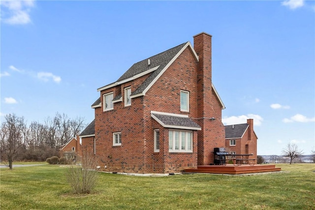 view of home's exterior featuring a lawn and a wooden deck