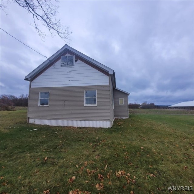 view of property exterior with a yard