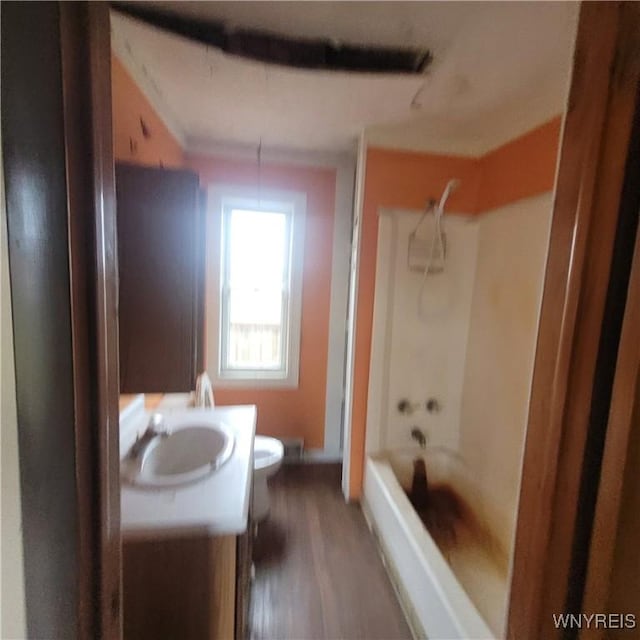 full bathroom featuring bathtub / shower combination, wood-type flooring, vanity, and toilet