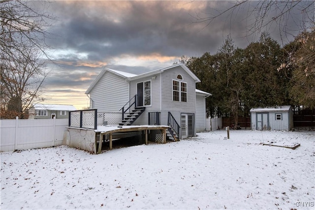 snow covered property featuring a shed