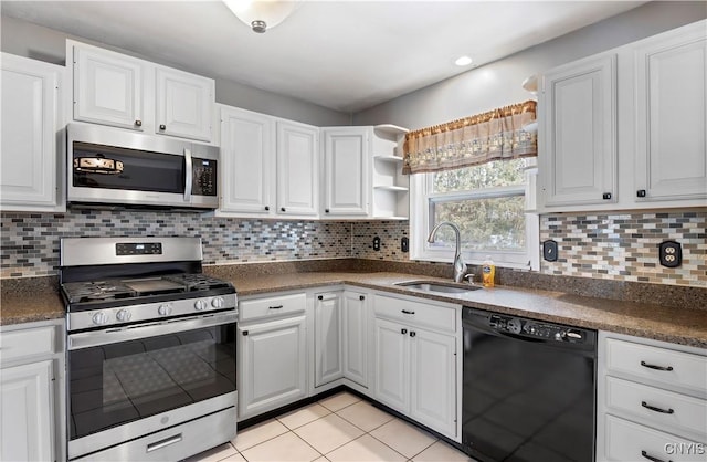 kitchen featuring decorative backsplash, white cabinetry, sink, and appliances with stainless steel finishes