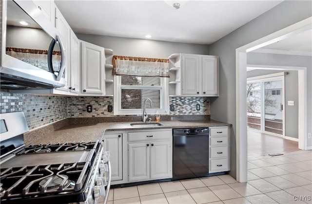 kitchen with white cabinetry, sink, stainless steel appliances, decorative backsplash, and light tile patterned floors