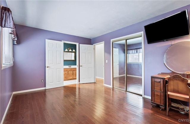 unfurnished bedroom featuring hardwood / wood-style flooring and a closet