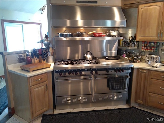 kitchen featuring backsplash, double oven range, and light tile patterned flooring