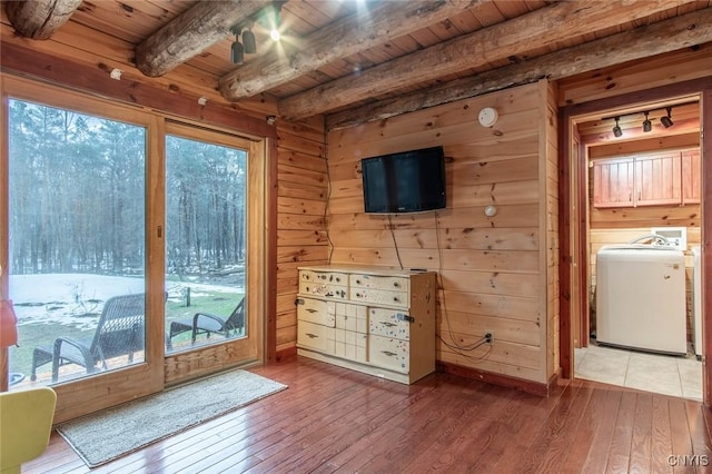 entryway with wood walls, wooden ceiling, beamed ceiling, washer / dryer, and wood-type flooring