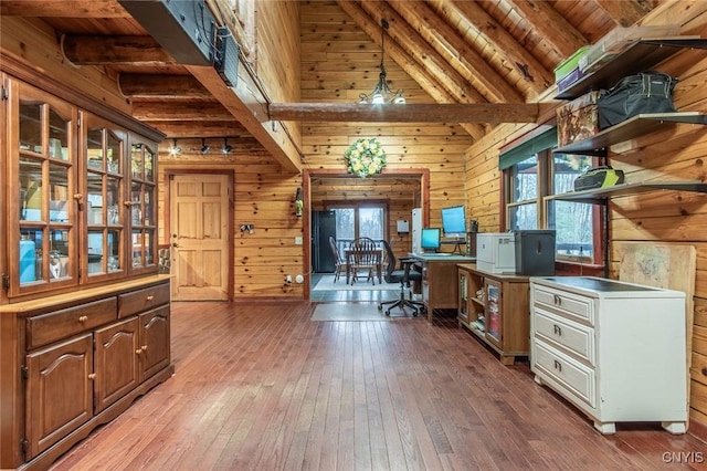 office space featuring beamed ceiling, wooden ceiling, wooden walls, and light hardwood / wood-style flooring