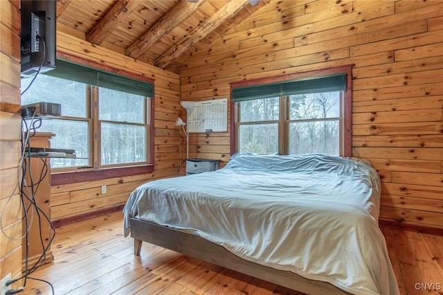 bedroom with wood ceiling, multiple windows, wood walls, and lofted ceiling with beams