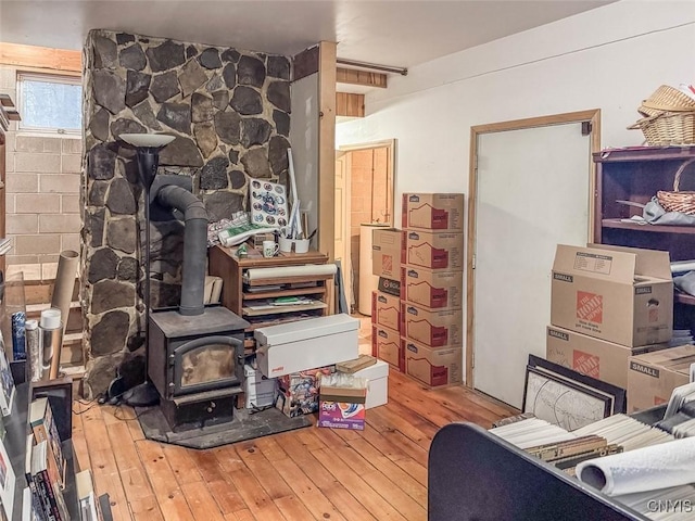 interior space featuring wood-type flooring and a wood stove