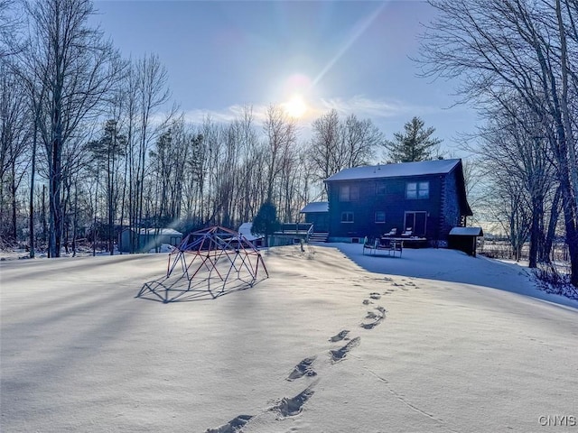 view of snow covered rear of property