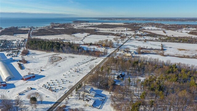 snowy aerial view featuring a water view