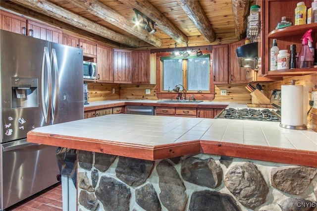 kitchen featuring sink, beamed ceiling, tile counters, wood ceiling, and stainless steel appliances