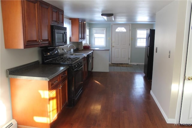 kitchen featuring black appliances, dark hardwood / wood-style floors, sink, and a baseboard radiator