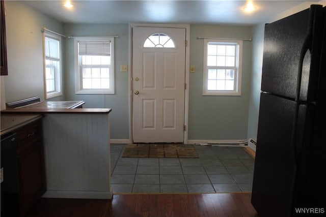 interior space featuring baseboard heating and dark hardwood / wood-style floors