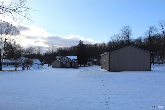 snowy yard featuring an outdoor structure