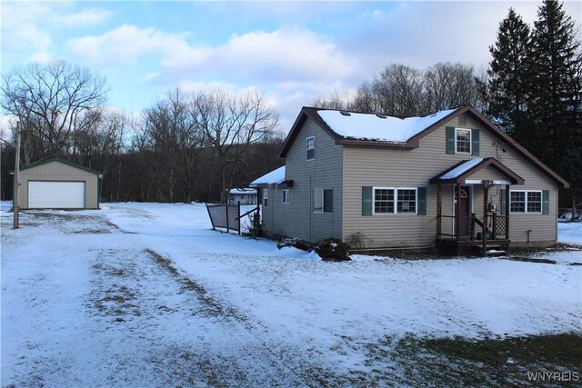 view of front of property with a garage and an outbuilding