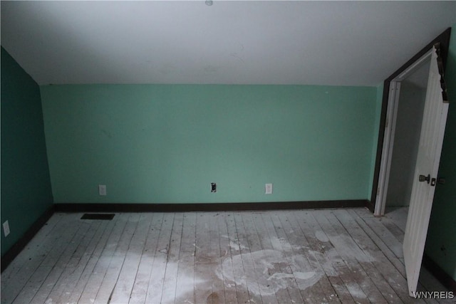 additional living space with lofted ceiling and light hardwood / wood-style flooring