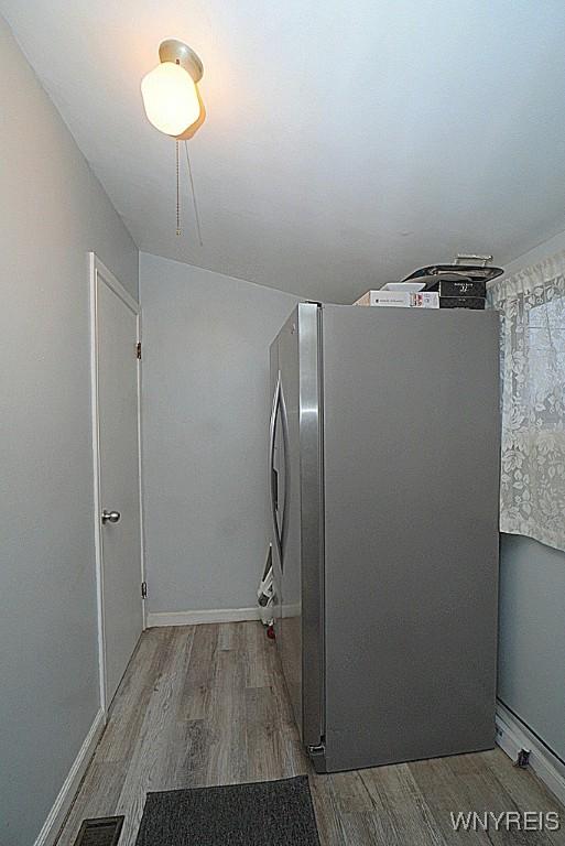 kitchen with stainless steel fridge and light wood-type flooring