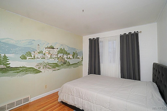 bedroom with wood-type flooring