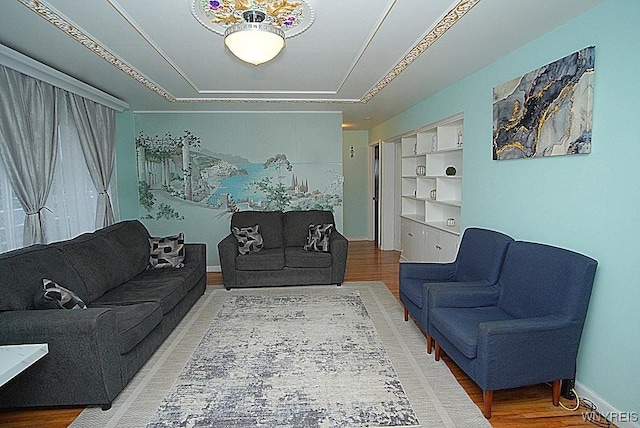 living room featuring built in features and hardwood / wood-style flooring