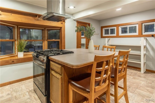 kitchen featuring gas stove and island exhaust hood