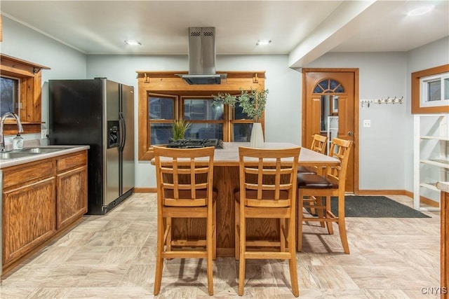 kitchen featuring island range hood, black fridge, and sink