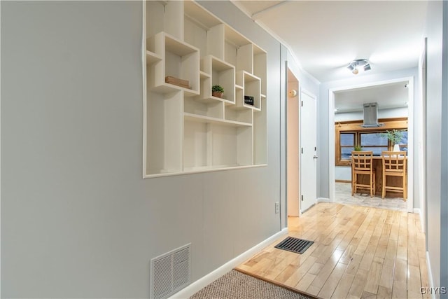 hallway with light hardwood / wood-style flooring