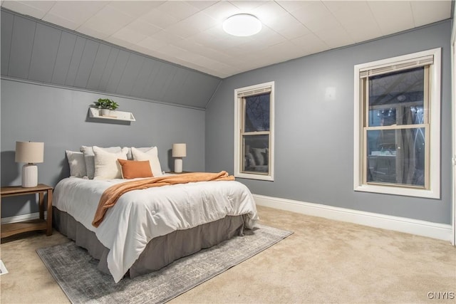 bedroom with light colored carpet and lofted ceiling