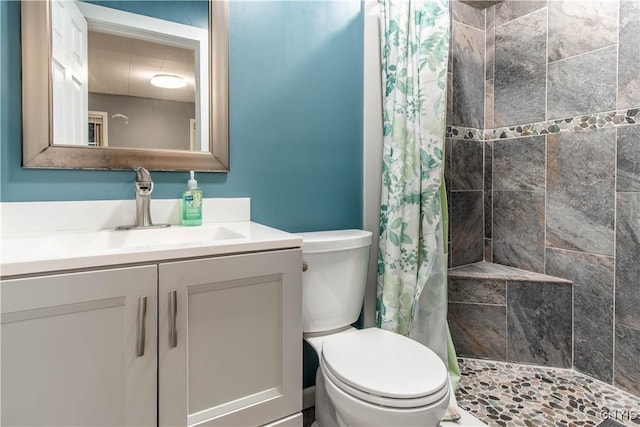 bathroom with vanity, toilet, and walk in shower