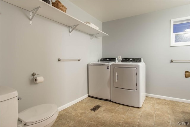 washroom featuring separate washer and dryer and light tile patterned floors