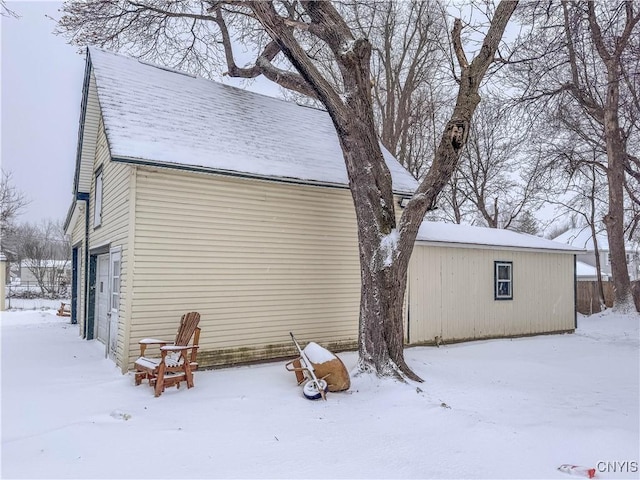 snow covered property featuring a garage