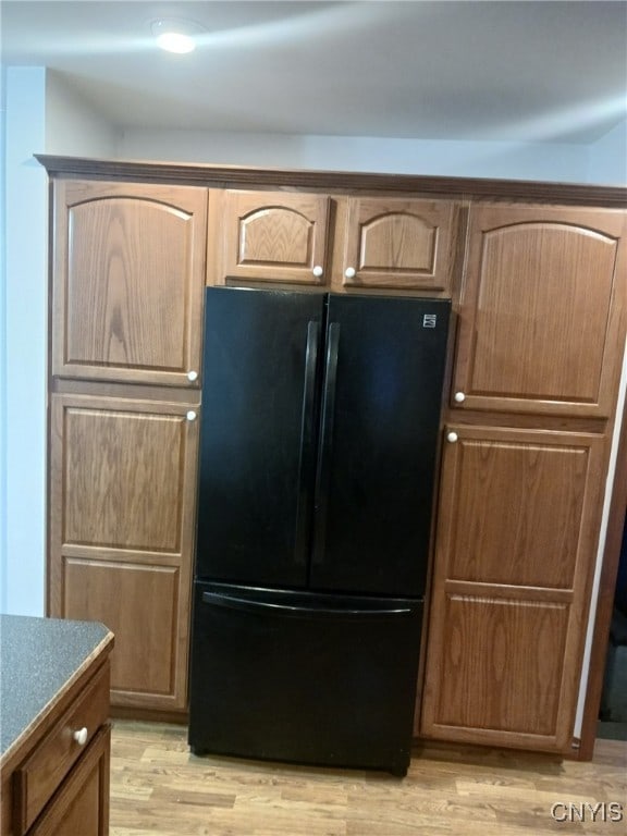 kitchen featuring black refrigerator and light wood-type flooring